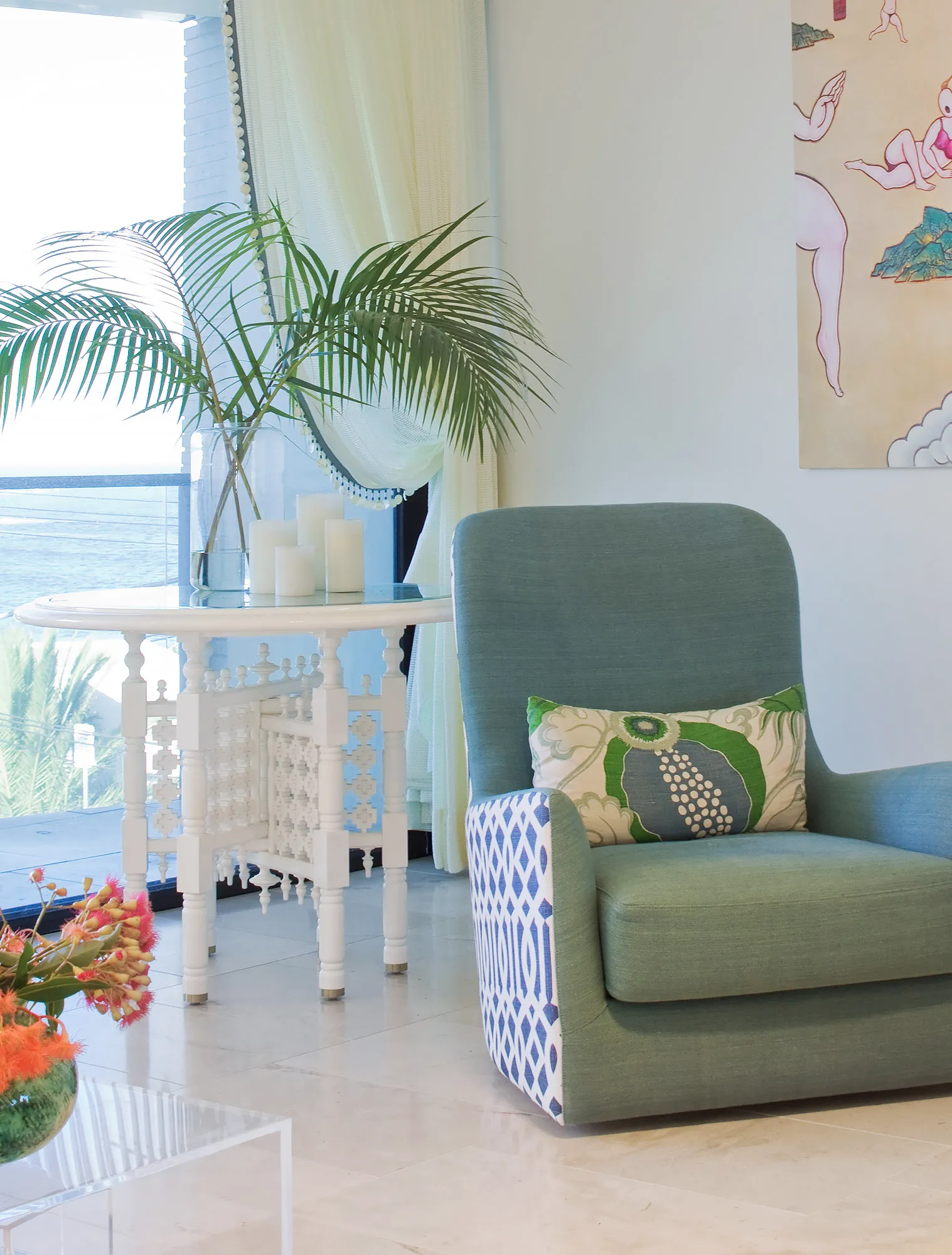Coastal armchair with teal upholstery and shell-trim curtain detail — bespoke window fabrication by Bronwyn Poole