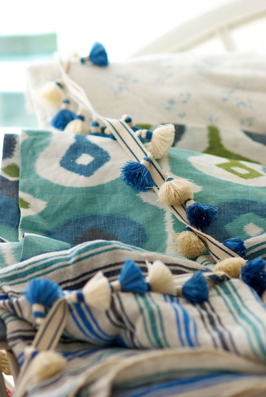 Blue ikat fabric with decorative tassels and coastal-inspired textiles