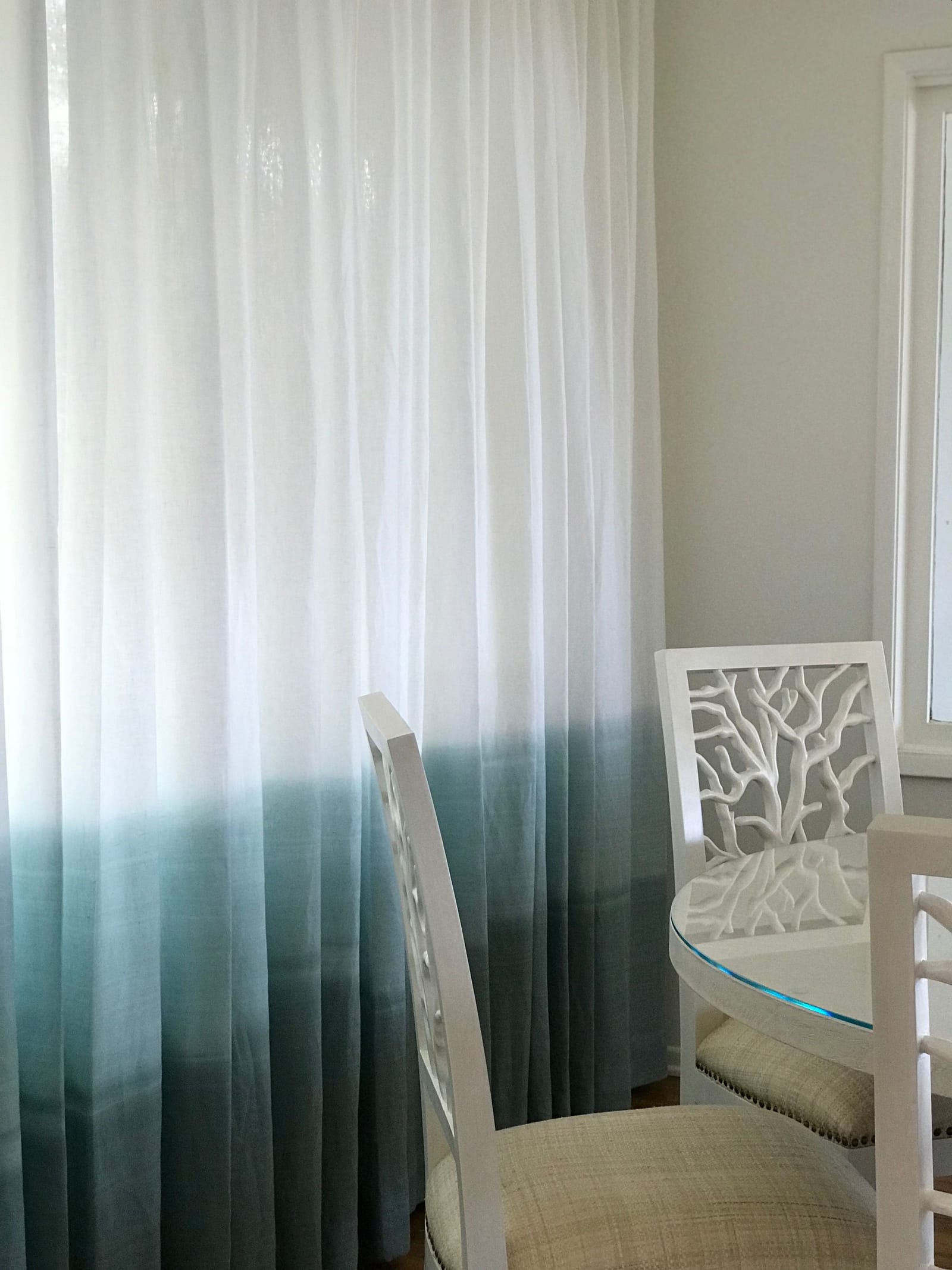 Ombre dip-dyed curtains with carved tree-back dining chair