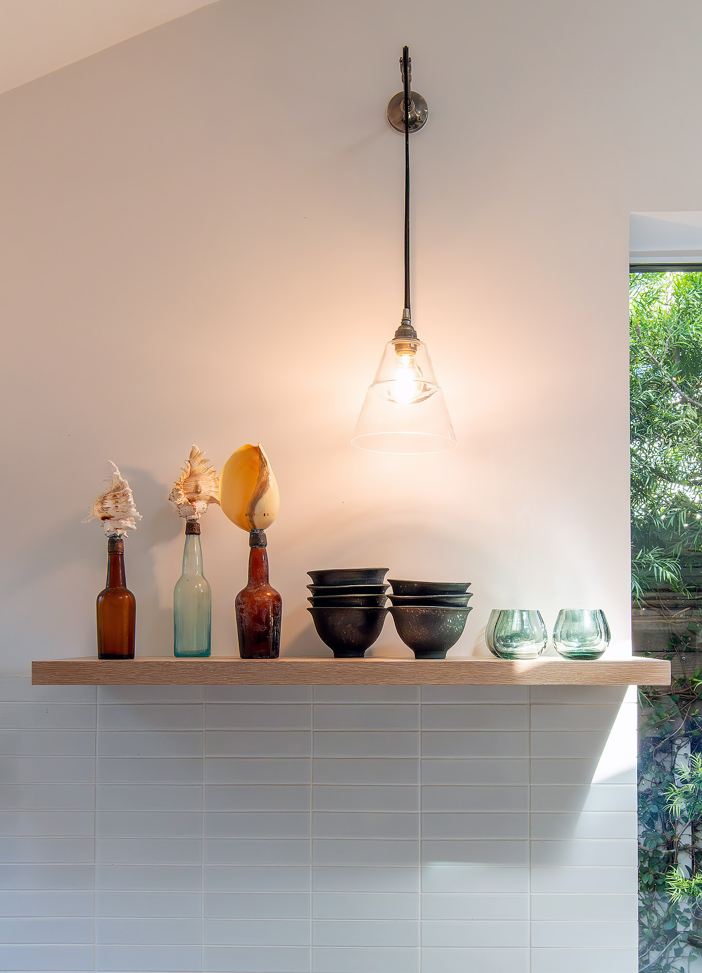 Kitchen shelf vignette shells bottles patinated bowls brass pendant white tile splashback — Bronwyn Poole Interiors Kitchen shelf vignette shells bottles patinated bowls brass pendant white tile splashback — Bronwyn Poole Interiors