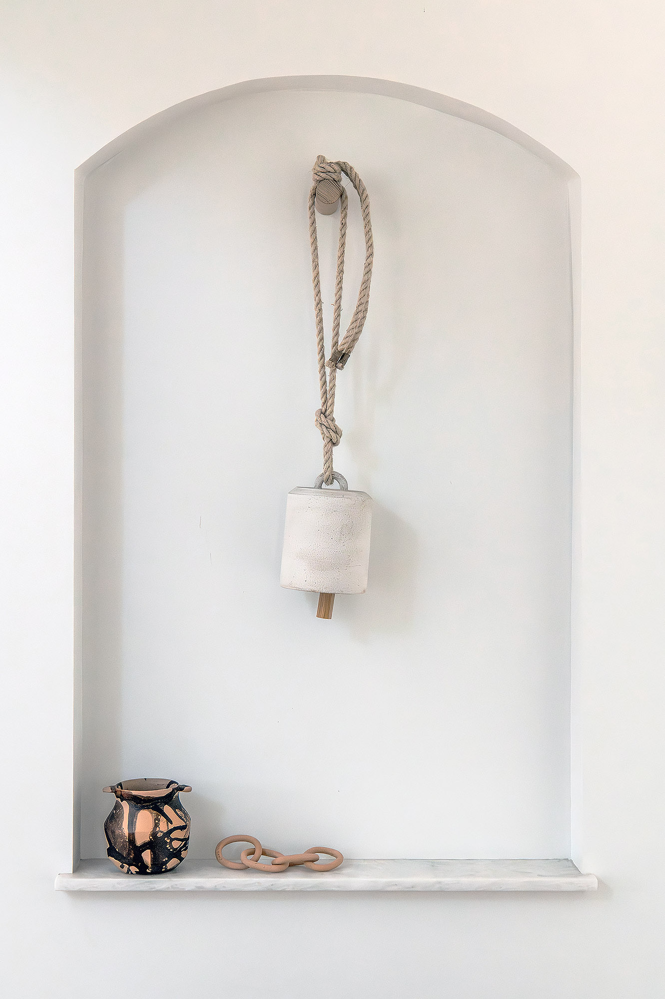 Living room arched niche rope hung concrete bell ceramic vessel terracotta chain links — Bronwyn Poole Interiors Living room arched niche rope hung concrete bell ceramic vessel terracotta chain links — Bronwyn Poole Interiors