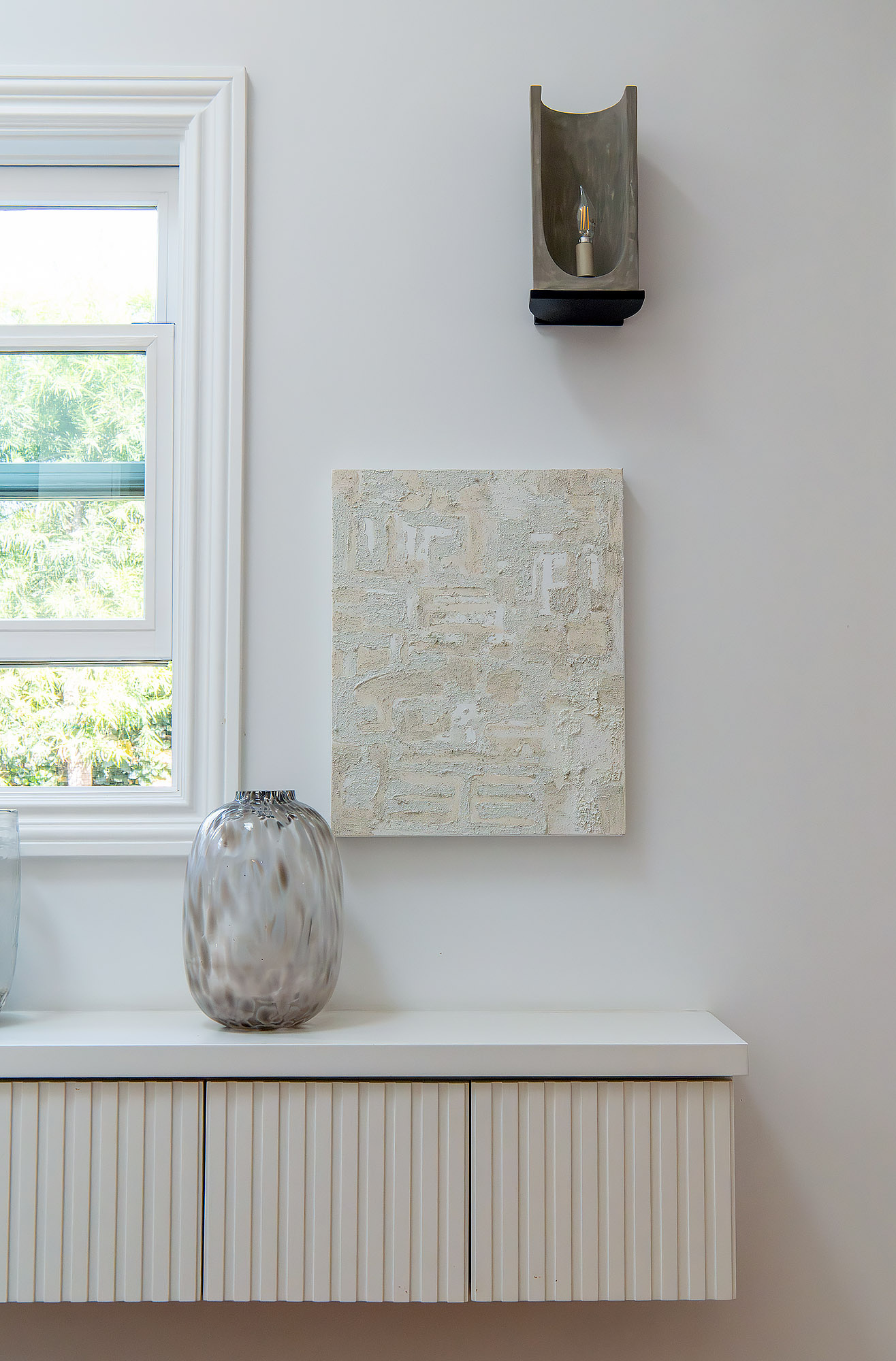 Living room bronze candle sconce textural plaster art tortoiseshell glass vase fluted credenza — Bronwyn Poole Interiors Living room bronze candle sconce textural plaster art tortoiseshell glass vase fluted credenza — Bronwyn Poole Interiors