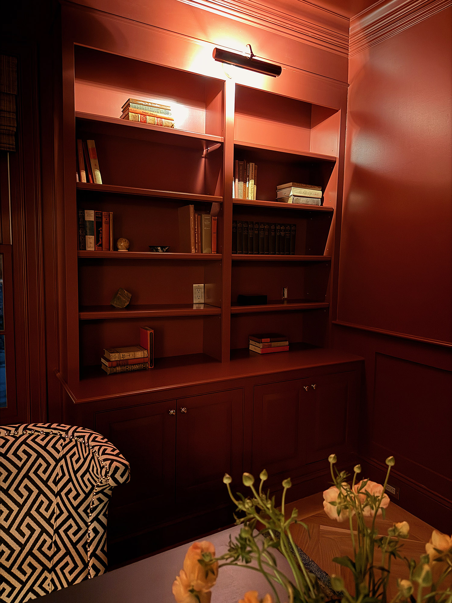 Den crimson built in bookshelves brass picture light vintage books greek key armchair corner ranunculus — Bronwyn Poole Interiors