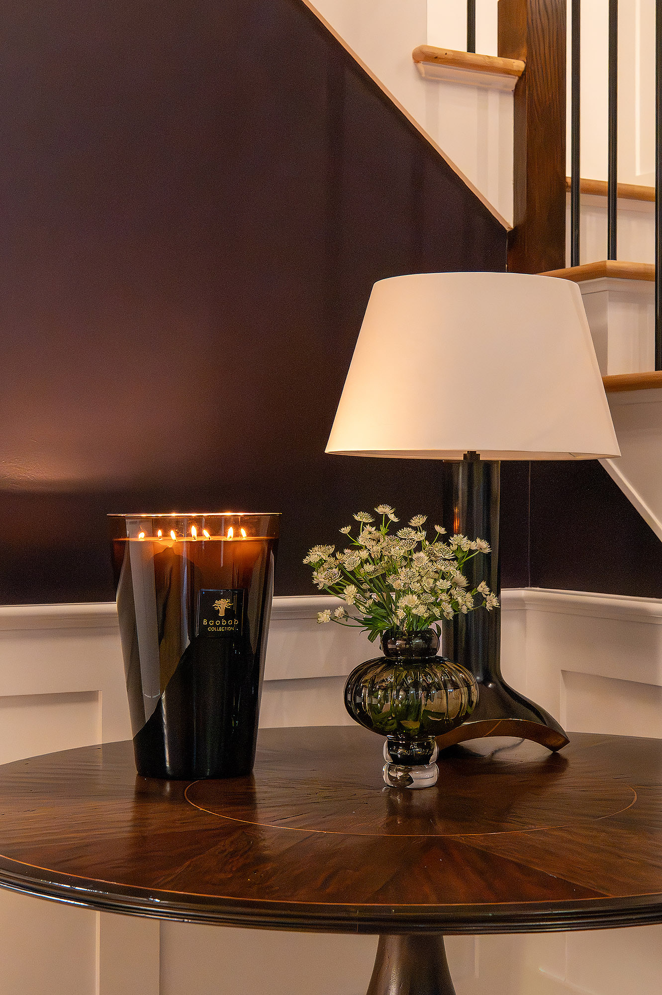 Foyer pedestal table detail baobab candle green vase white flowers walnut lamp aubergine walls — Bronwyn Poole Interiors