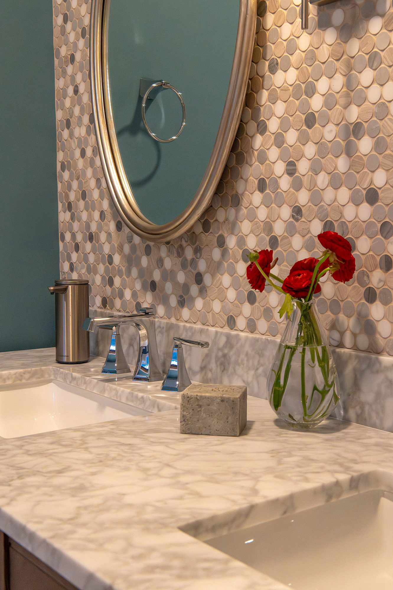 Jack jill bathroom vanity detail marble counter pebble mosaic tile oval mirror red ranunculus vase — Bronwyn Poole Interiors