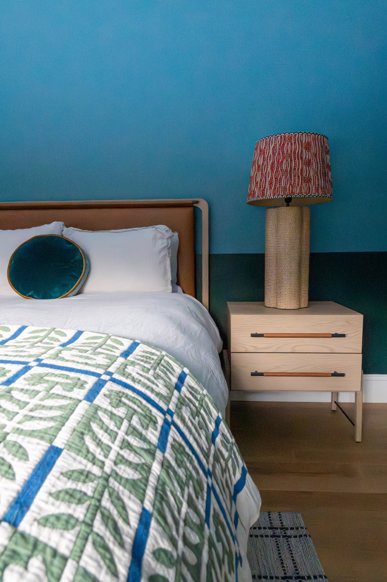 Jack jill bedroom bedside detail teal walls orange headboard rattan lamp block print shade leaf quilt velvet pillow — Bronwyn Poole Interiors