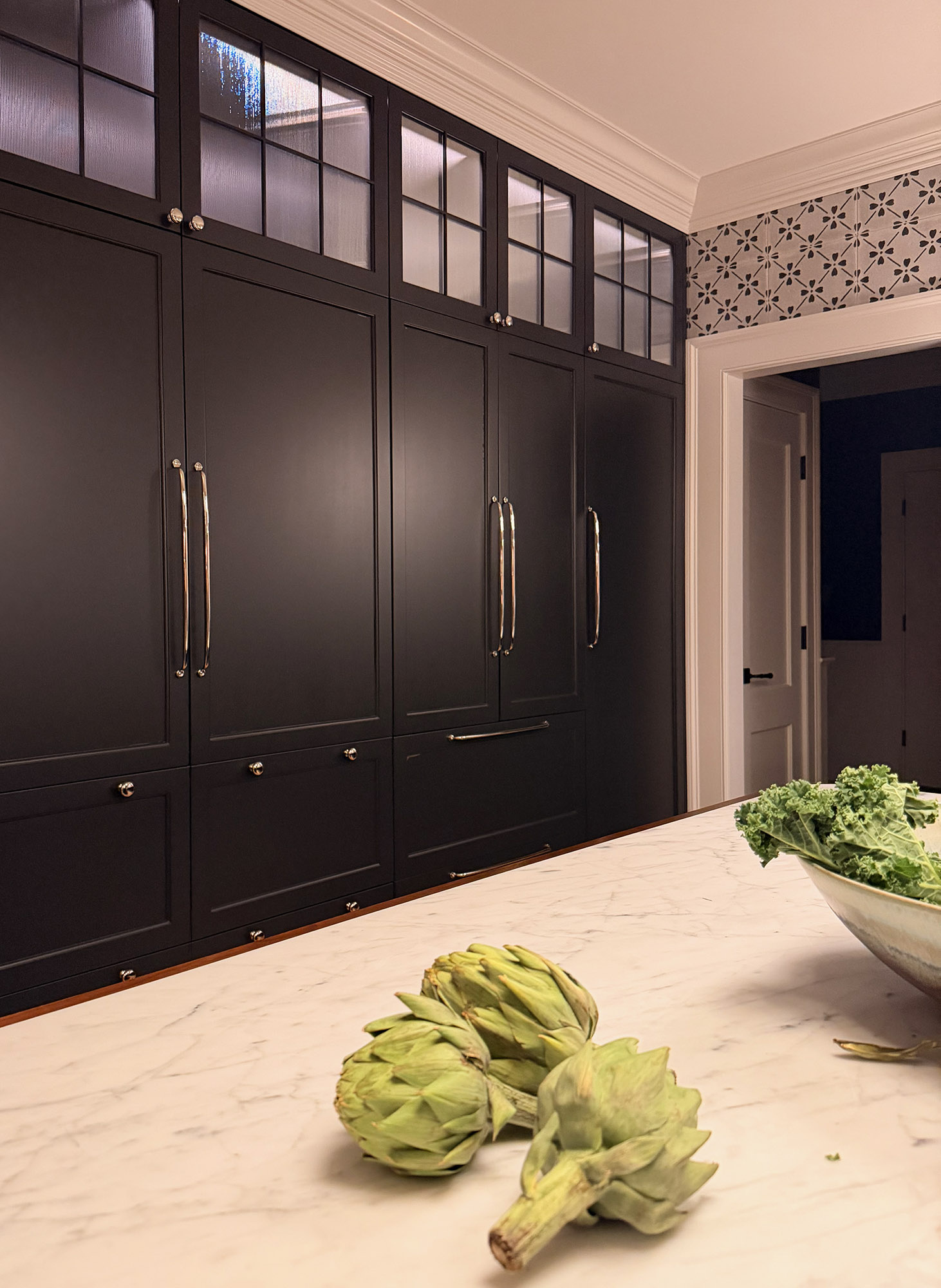 Kitchen black paneled pantry cabinets glass uppers marble island encaustic cement tile backsplash artichokes kale still life — Bronwyn Poole Interiors Kitchen black paneled pantry cabinets glass uppers marble island encaustic cement tile backsplash artichokes kale still life — Bronwyn Poole Interiors