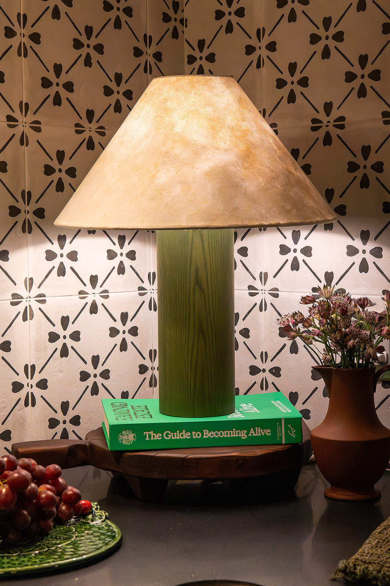 Kitchen counter detail green wood lamp floral cement tile terracotta vase pink blooms grapes — Bronwyn Poole Interiors