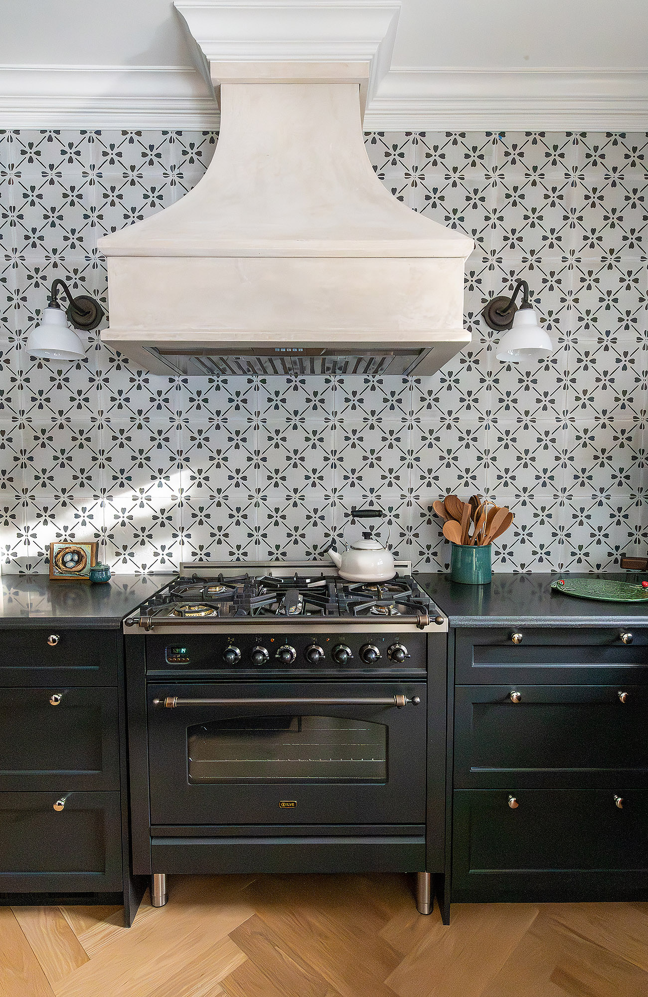 Kitchen range hood elevation plaster canopy black ilve stove floral cement tile vintage sconces herringbone floor — Bronwyn Poole Interiors