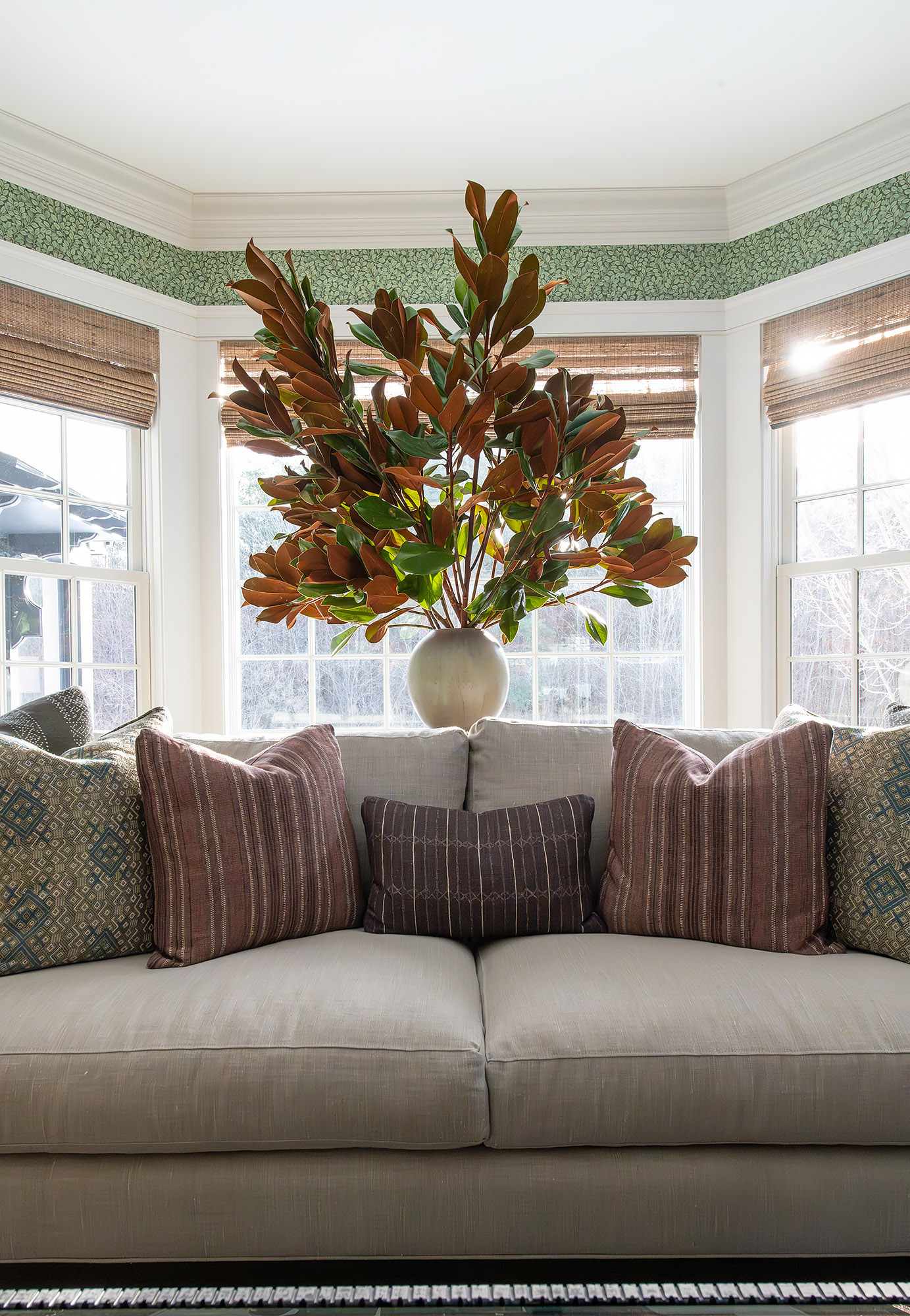 Linen sofa striped pillows magnolia branches bay window green wallpaper woven shade — Bronwyn Poole Interiors Linen sofa striped pillows magnolia branches bay window green wallpaper woven shade — Bronwyn Poole Interiors