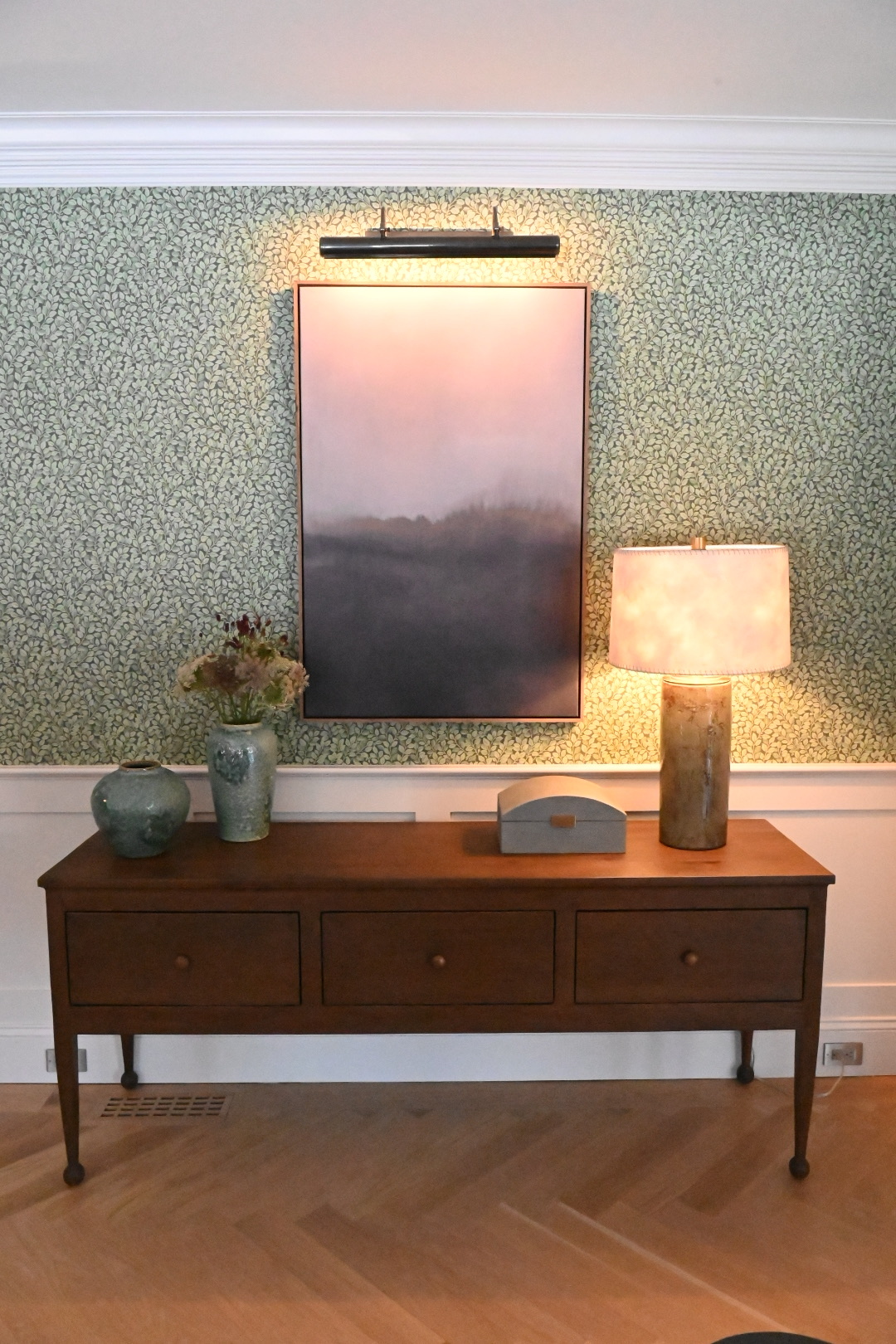 Living room shaker console vignette green leaf wallpaper misty landscape painting bronze picture light celadon vases dried flowers glass cylinder lamp — Bronwyn Poole Interiors Living room shaker console vignette green leaf wallpaper misty landscape painting bronze picture light celadon vases dried flowers glass cylinder lamp — Bronwyn Poole Interiors