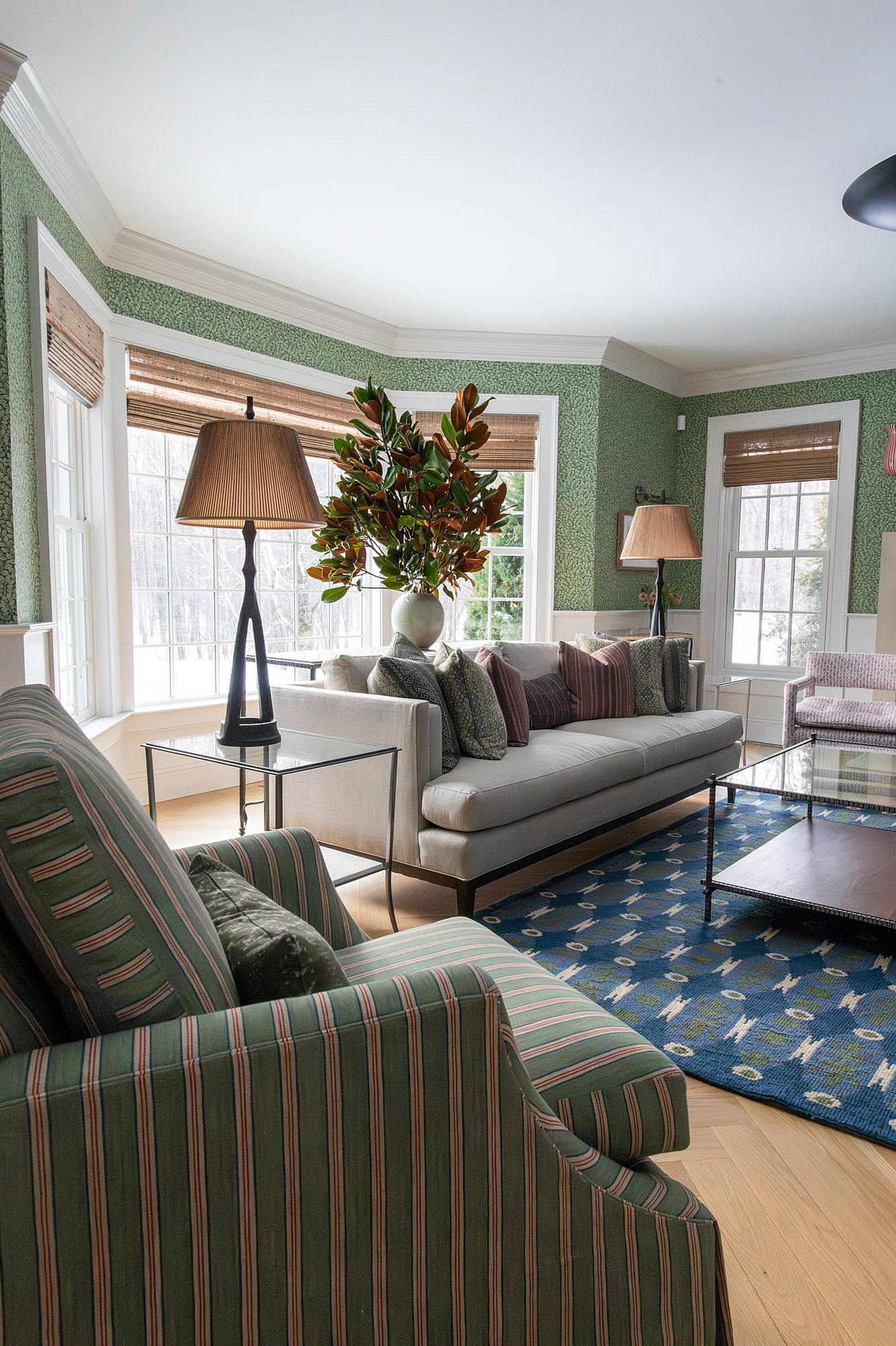 Living room side view green striped armchairs grey sofa pleated shade floor lamp magnolia branches blue rug bay window — Bronwyn Poole Interiors Living room side view green striped armchairs grey sofa pleated shade floor lamp magnolia branches blue rug bay window — Bronwyn Poole Interiors