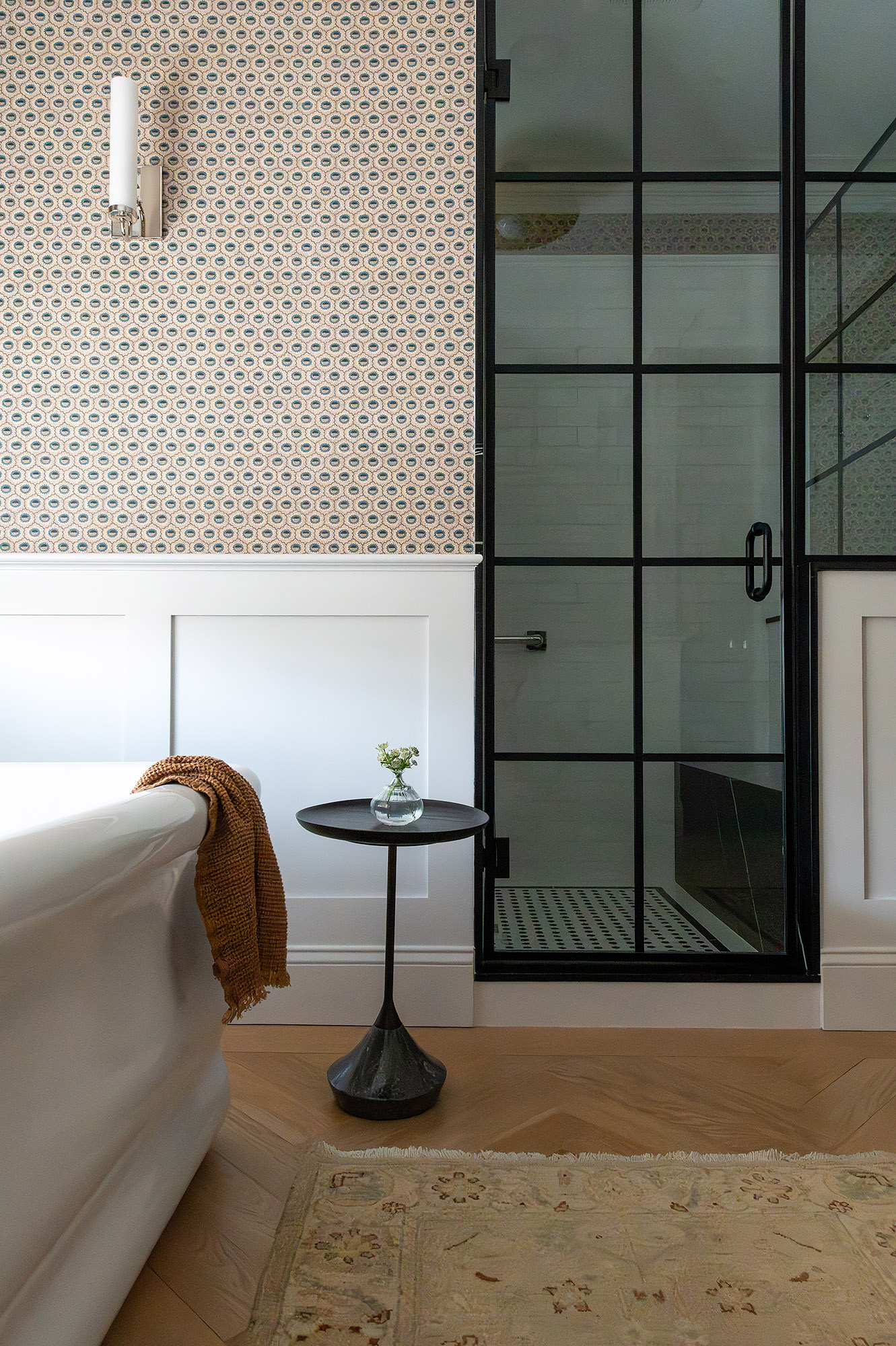 Primary bathroom iron frame shower terracotta wallpaper freestanding tub black spool side table amber throw — Bronwyn Poole Interiors Primary bathroom iron frame shower terracotta wallpaper freestanding tub black spool side table amber throw — Bronwyn Poole Interiors