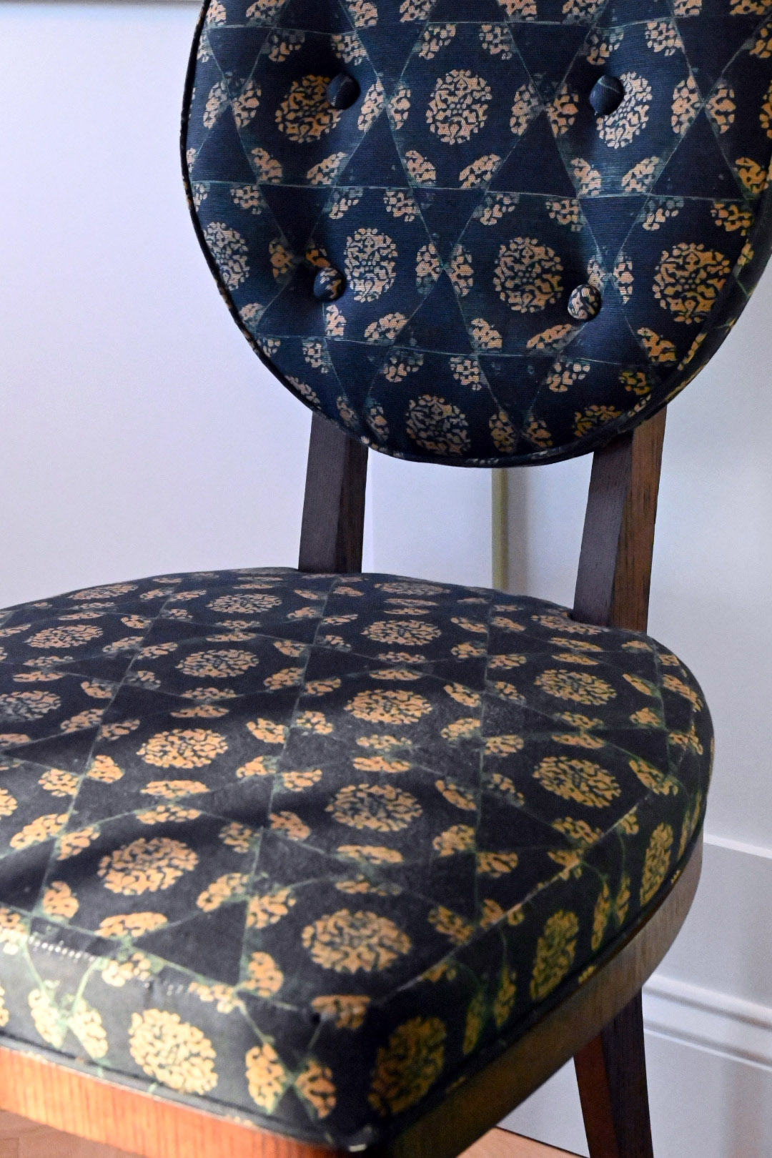 Primary bedroom block print side chair detail navy marigold medallion tufted back walnut frame — Bronwyn Poole Interiors