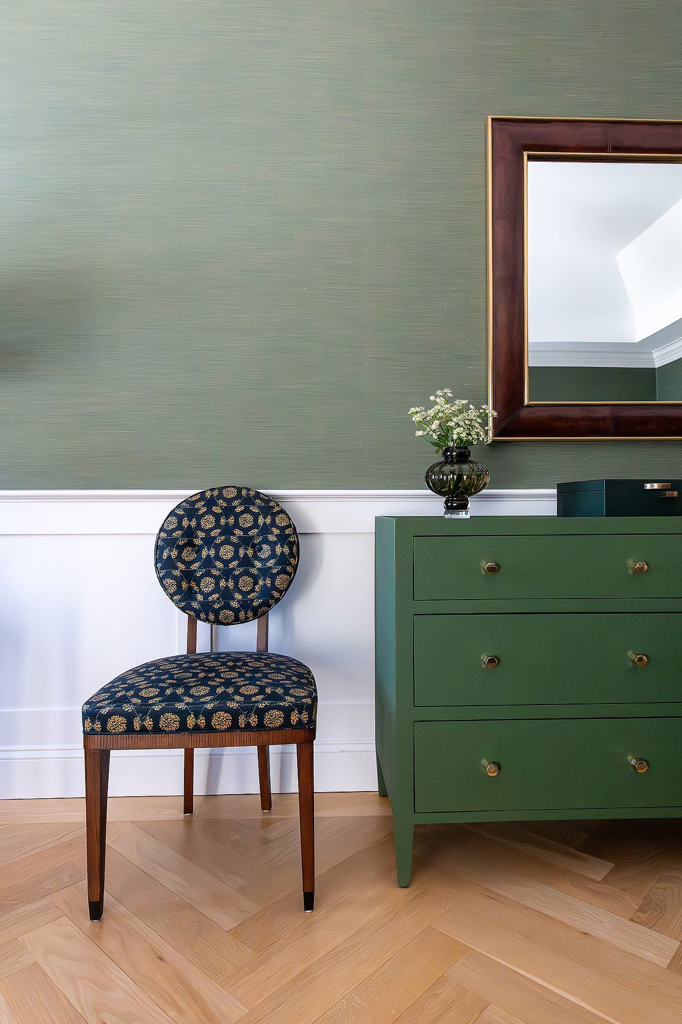 Primary bedroom vignette green grasscloth painted dresser mahogany mirror block print side chair white daisies — Bronwyn Poole Interiors