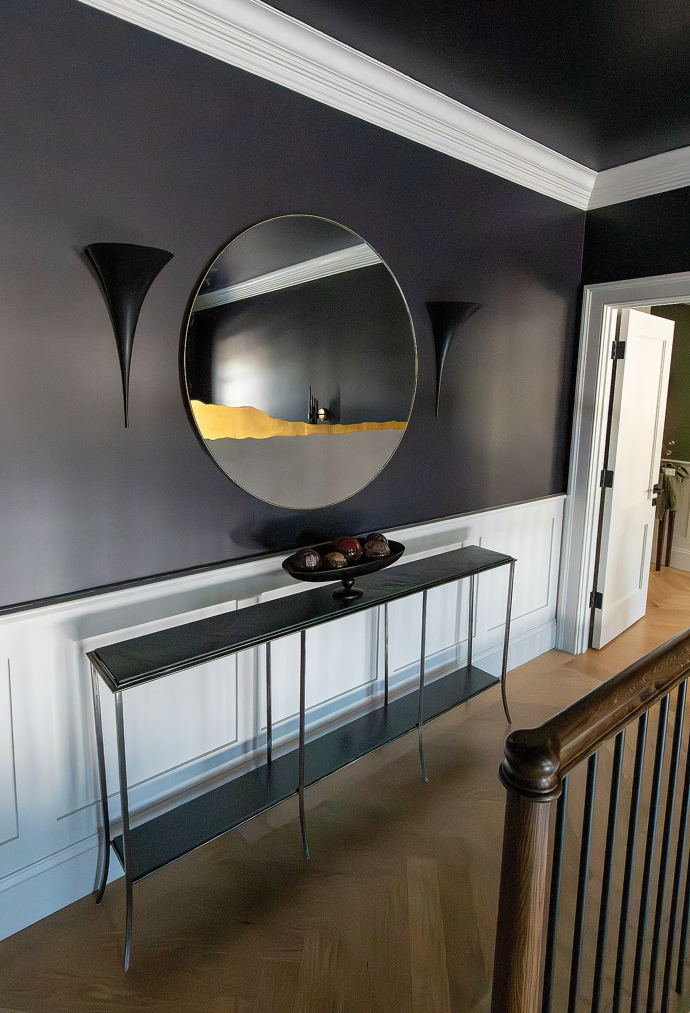 Upstairs hallway aubergine walls round mirror gold accent black sconces iron console table — Bronwyn Poole Interiors