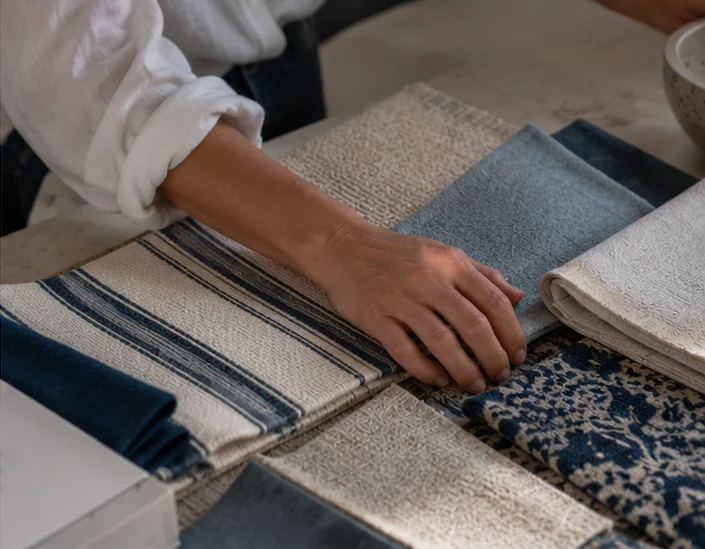 Design inspiration: blue and natural textile samples being considered together