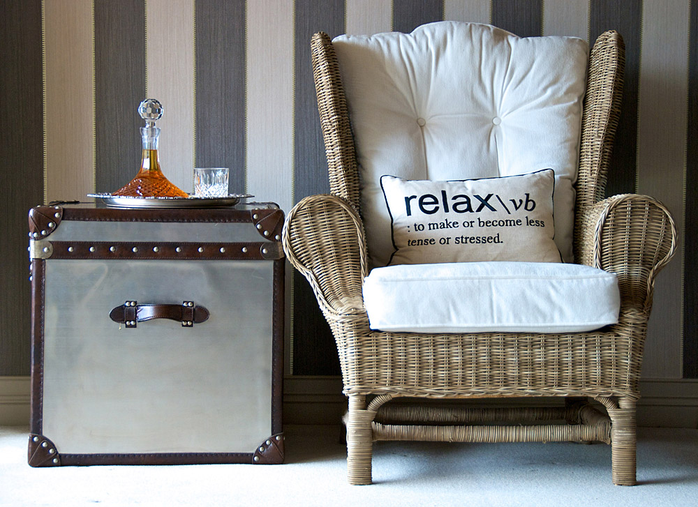 Harbourside rattan wingback chair relax cushion trunk side table decanter striped wallpaper detail — Bronwyn Poole Interiors