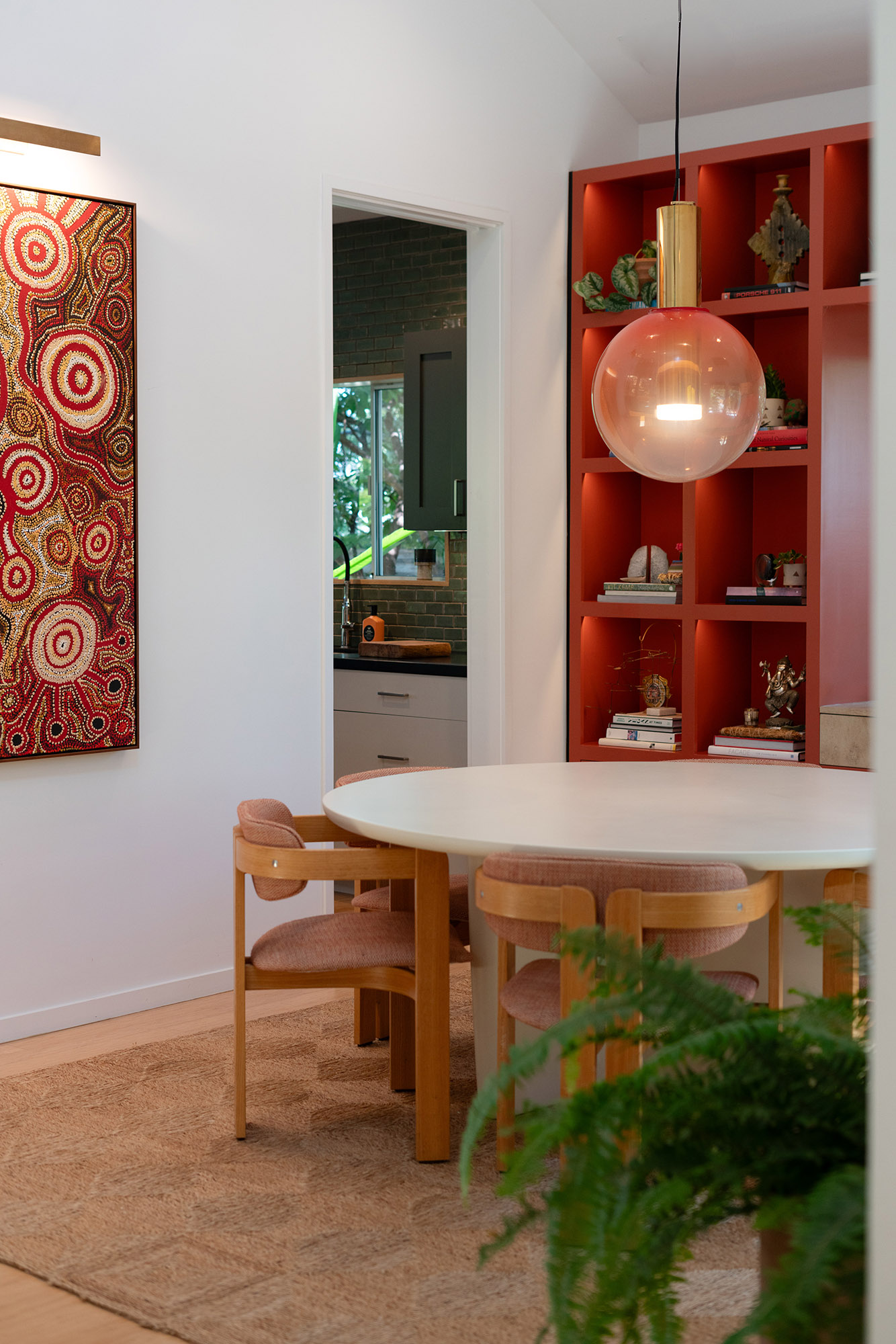 Santa monica dining room aboriginal art round table amber pendant red shelves detail — Bronwyn Poole Interiors Santa monica dining room aboriginal art round table amber pendant red shelves detail — Bronwyn Poole Interiors