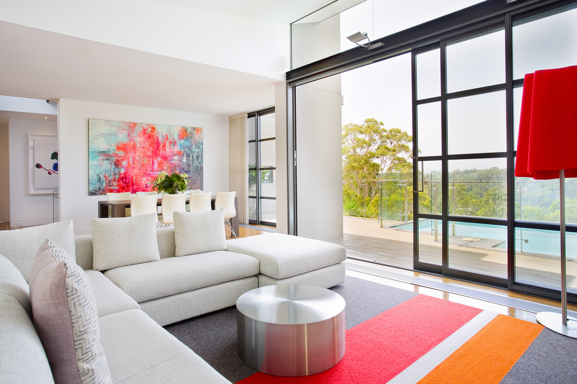 Bronwyn Poole Interiors Contemporary Open Plan White Sectional Abstract Art Steel Glass Doors Striped Rug — Interior Design by Bronwyn Poole
