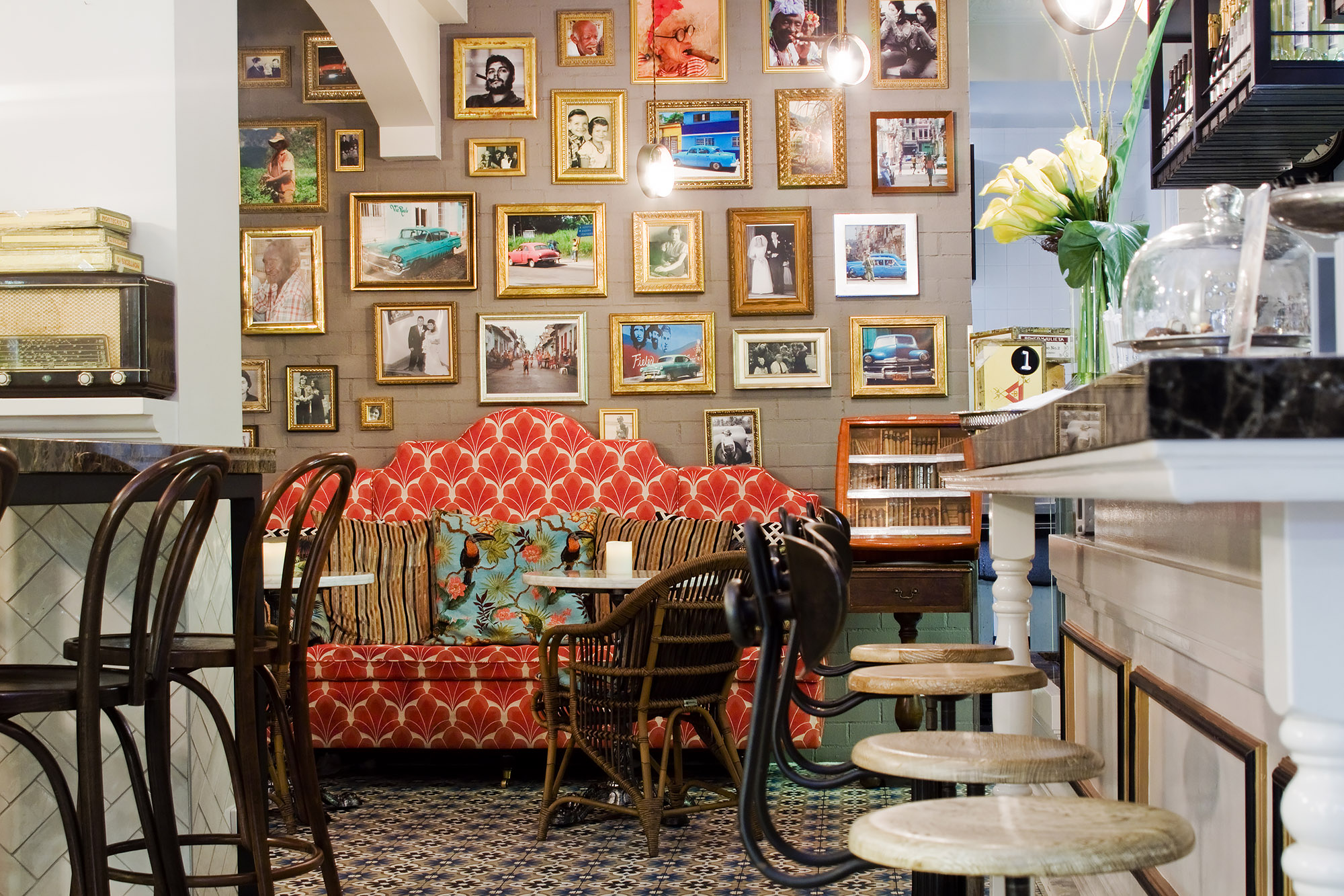 Bronwyn Poole Interiors Cuban Cafe Red Fan Banquette Gold Frame Gallery Wall Rattan Chairs Marble Tables — Interior Design by Bronwyn Poole