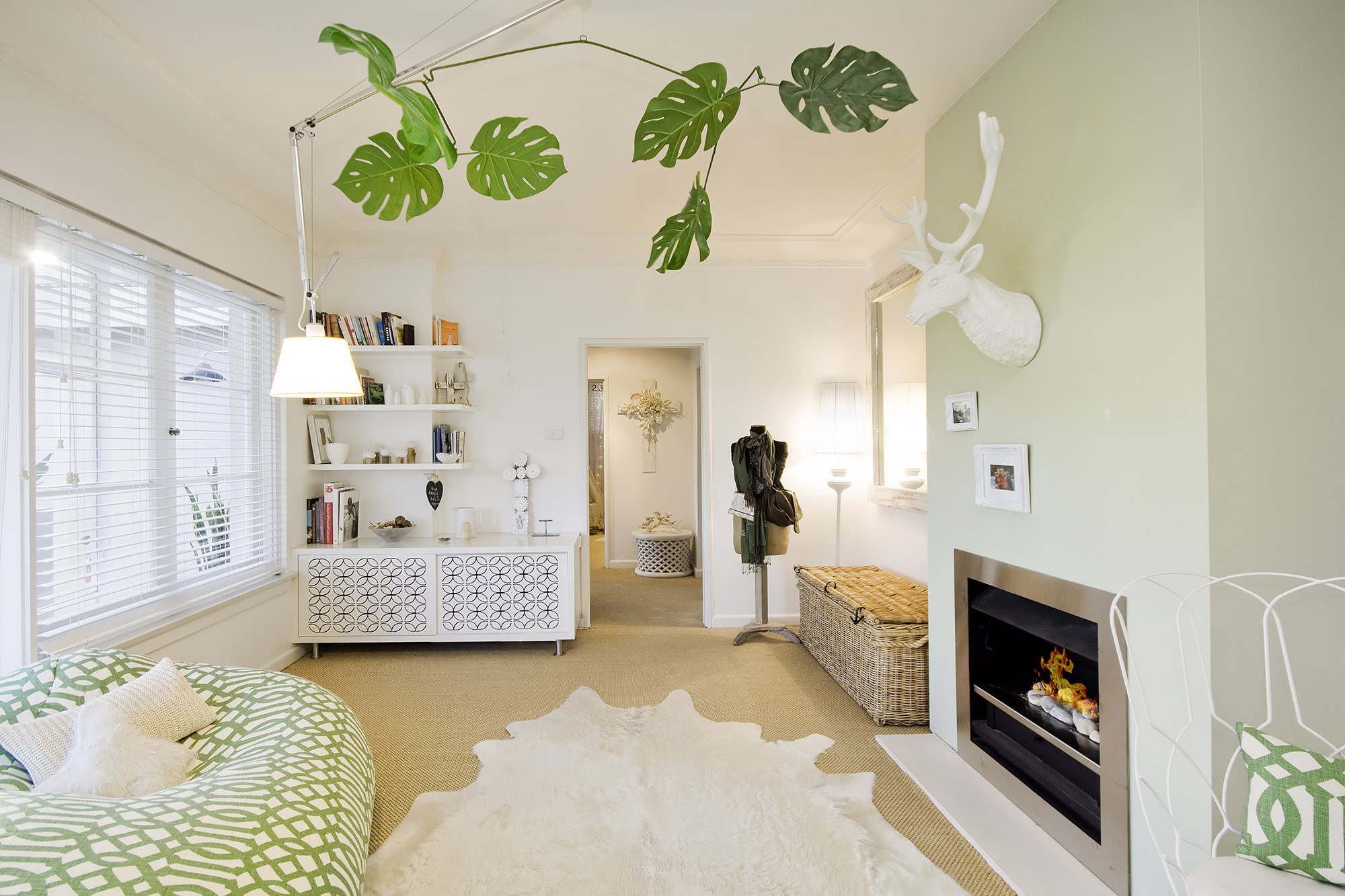 Bronwyn Poole Interiors Eclectic Living Green Trellis Sofa Monstera Mobile Cowhide Rug Stag Head Fireplace — Interior Design by Bronwyn Poole