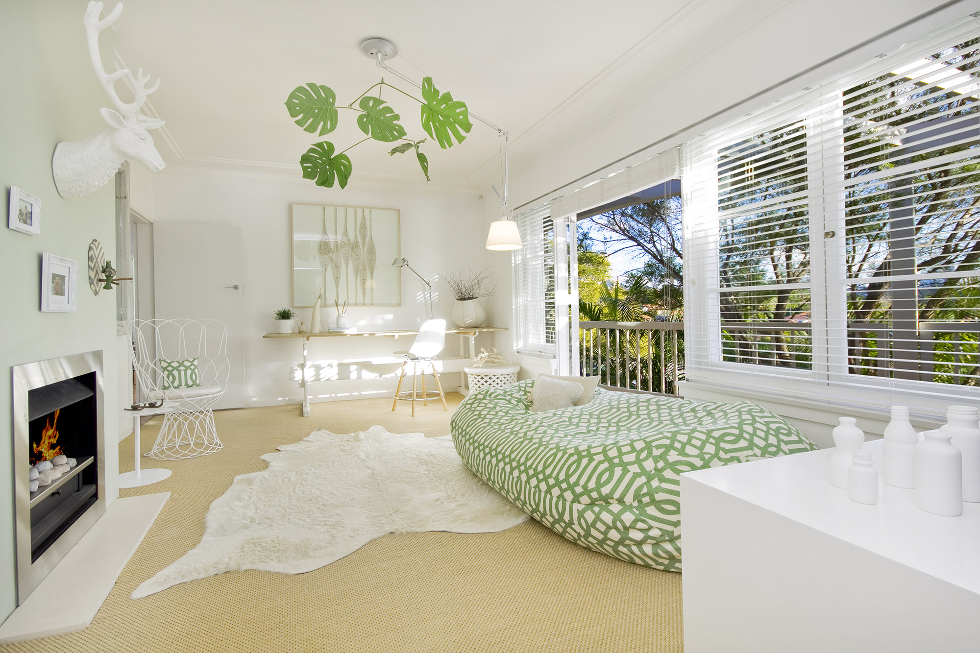 Bronwyn Poole Interiors Green Lounge Monstera Mobile Cowhide Rug Fireplace Venetian Blinds — Interior Design by Bronwyn Poole