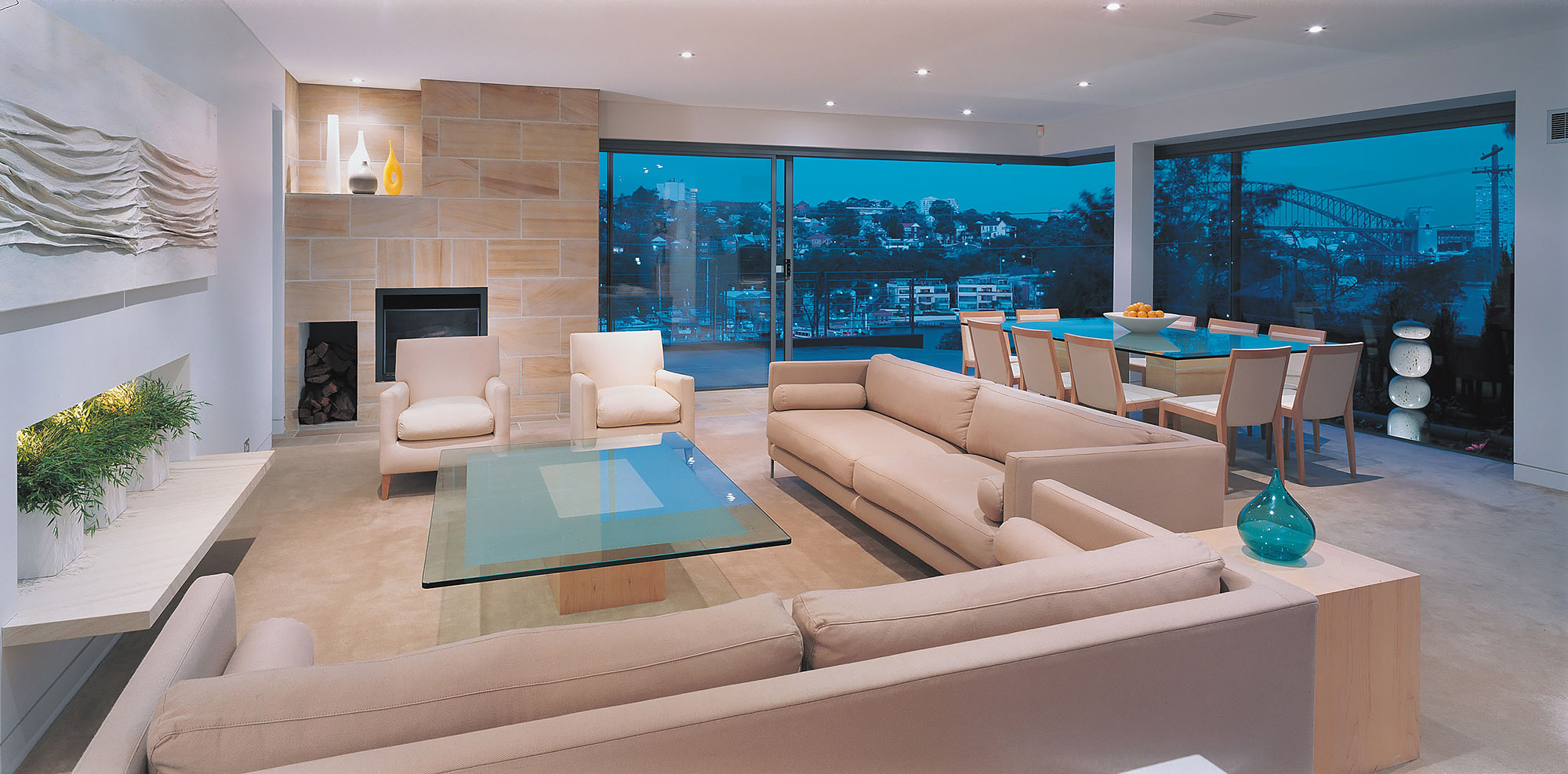 Bronwyn Poole Interiors Minimalist Living Sandstone Fireplace Cream Armchairs Glass Coffee Table Ceramic Vases — Interior Design by Bronwyn Poole
