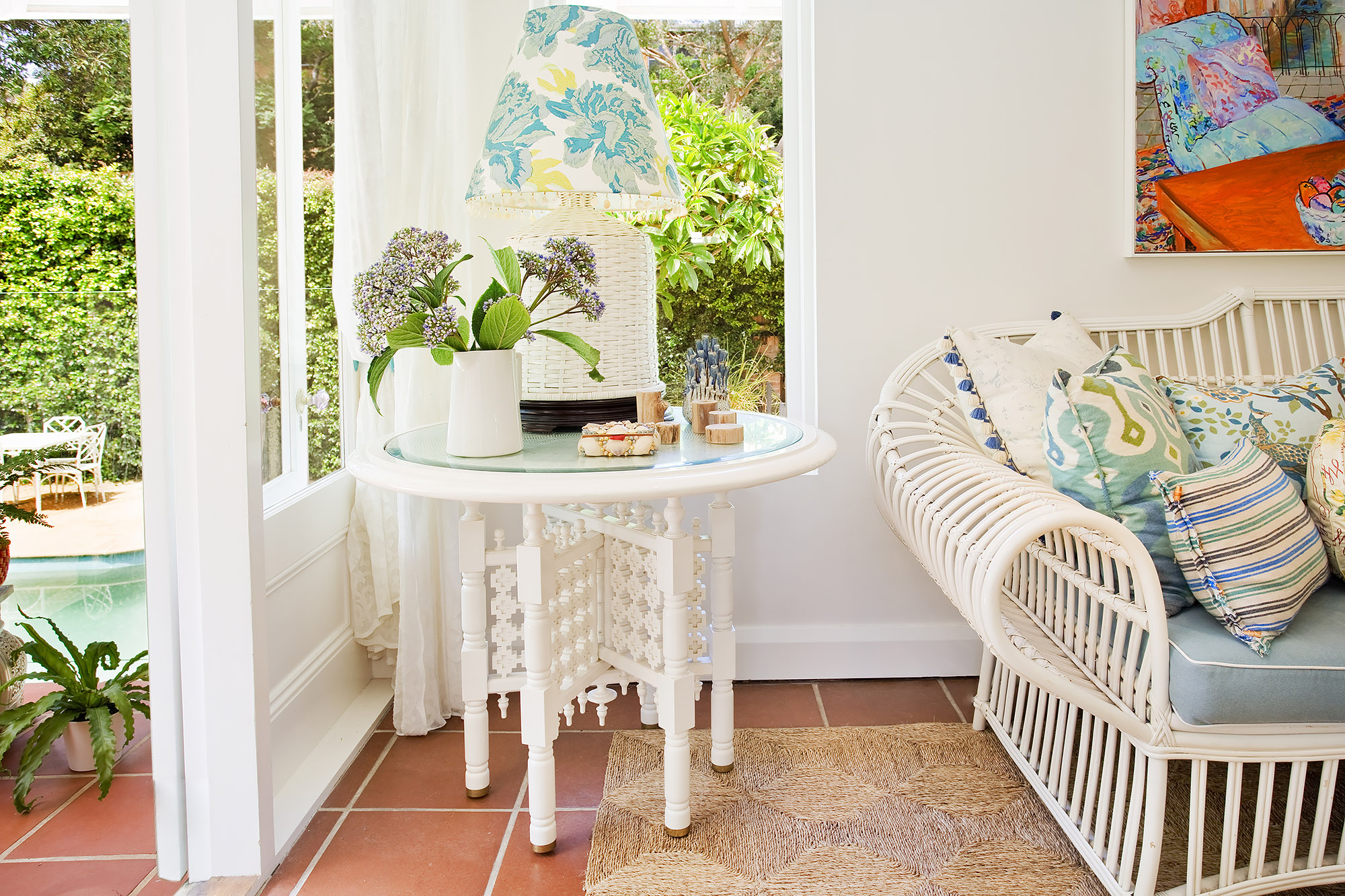 Bronwyn Poole Interiors Sunroom White Carved Table Floral Lampshade Rattan Settee Terracotta Tiles Pool View — Interior Design by Bronwyn Poole