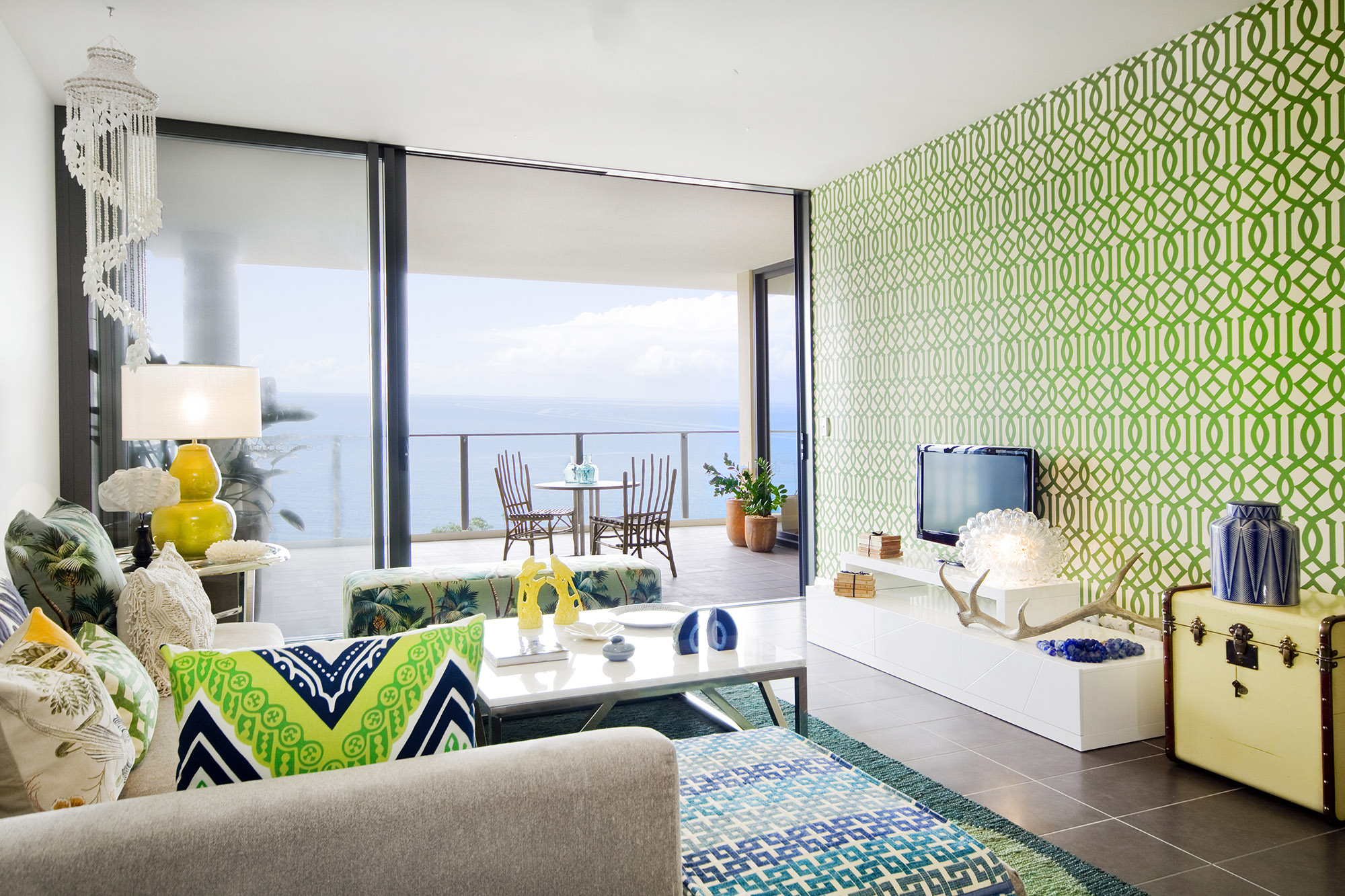 Bronwyn Poole Interiors Tropical Living Green Trellis Wallpaper Chevron Cushions Ocean View Shell Chandelier — Interior Design by Bronwyn Poole