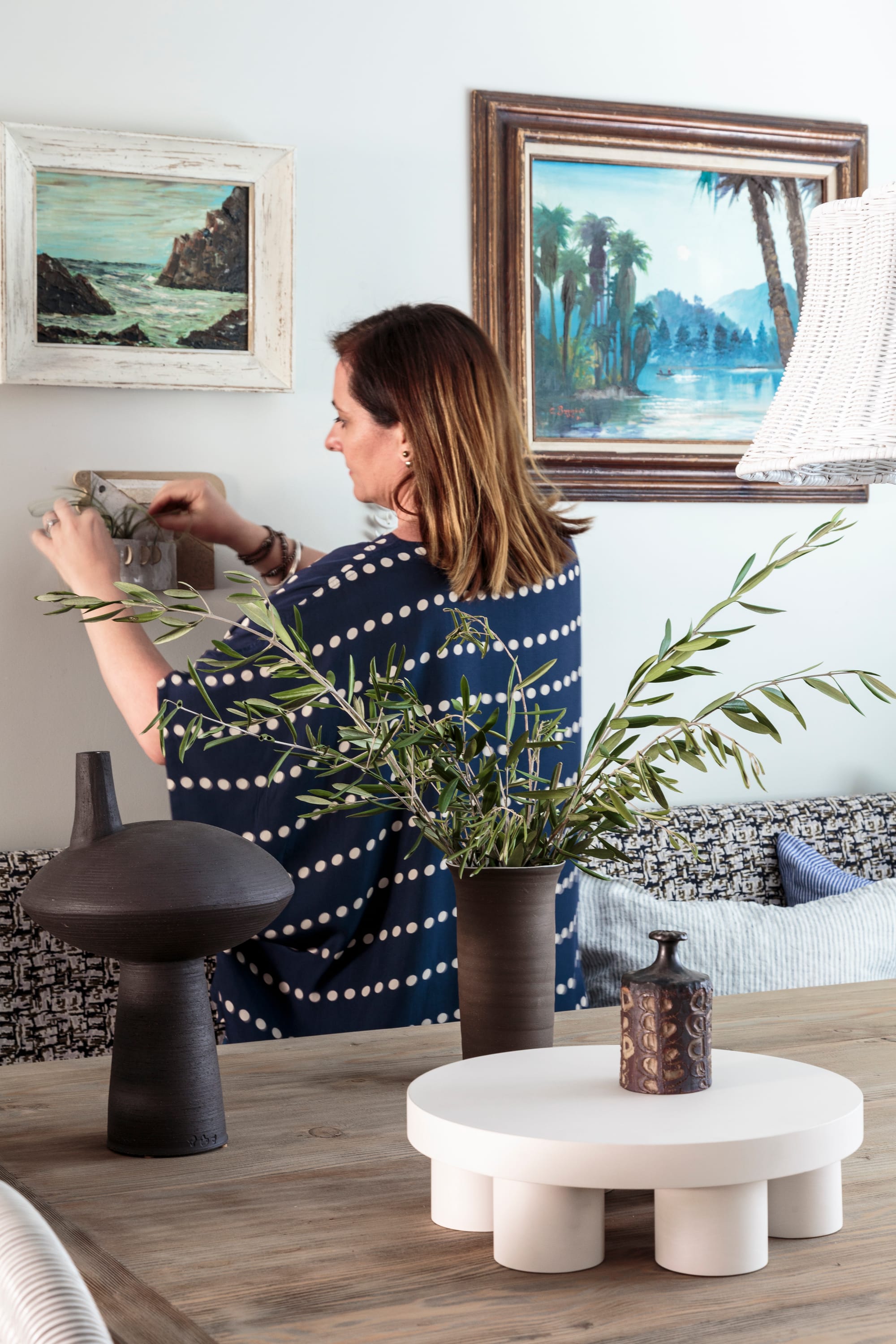 Interior designer working on wall styling in a beautifully designed space
